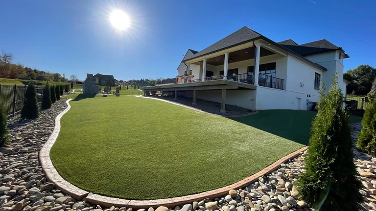 Pet-friendly artificial grass installed in an Atlanta residential yard, ensuring a safe and durable play area for pets with advanced turf technology.